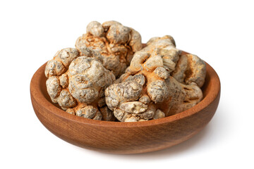 Dried notoginseng roots in the wooden bowl, isolated on the white background.