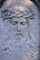 A very weathered old sandstone relief showing the suffering Jesus Christ with his crown.