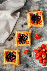 Sweets, cake, cookies with strawberries on table with great background with blueberries, spoon, jam...