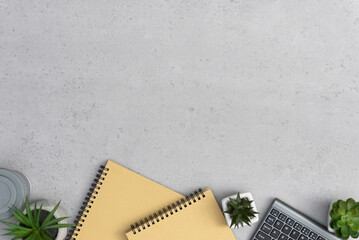 Copy space on concrete background. Office desk working space with coffee cup, succulents and notebook.