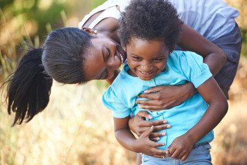 Ive got you. A happy young african mother spending time with her daughter while outdoors in nature.