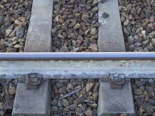 detail of the railway tracks, concrete sleepers on the paved