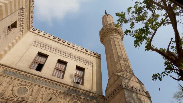 Look up Al Azhar mosque against blue sky, Ornamended minaret tower, Cairo. Egypt
