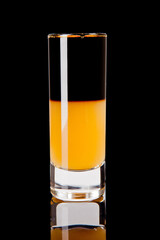 short layered alcoholic cocktail on black background