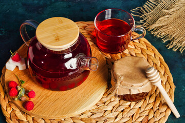 Honey, berry tea and honeysuckle on rustic blue background