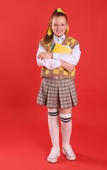 Cute indie girl with books on red background