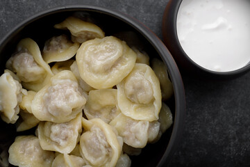 Boiled dumplings with meat in a pot