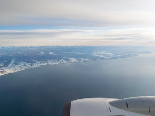 Naklejka na ściany i meble Snowy coastline viewed from an airplane (Hidaka, Hokkaido, Japan)