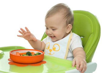 Cute little baby wearing bib while eating on white background