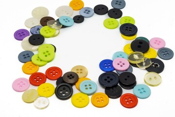 Set of different colored buttons on white background. Top of view