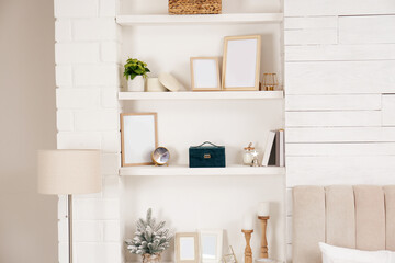 Obraz na płótnie Canvas Wall shelves with beautiful decor elements indoors. Interior design