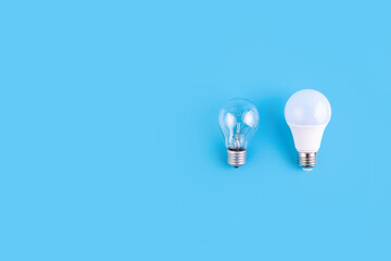 incandescent lamp and led lamps against on isolated blue background. Energy efficiency concept....