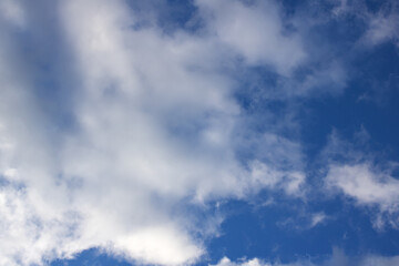 Fototapeta premium Fluffy clouds in the bright blue sky