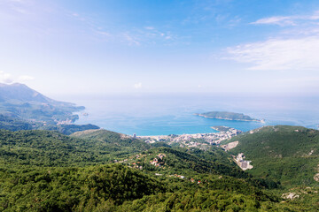 Fototapeta na wymiar Panoramic view of the city of Budva, Montenegro. Beautiful view from the mountains to the Adriatic Sea. The time of the year is summer.