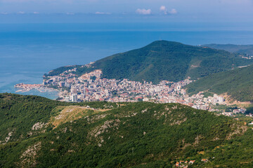 Fototapeta na wymiar Panoramic view of the city of Budva, Montenegro. Beautiful view from the mountains to the Adriatic Sea. The time of the year is summer.