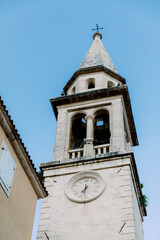Fototapeta na wymiar Religious architecture. Bell tower of ancient church. Bell tower of Church in Italy