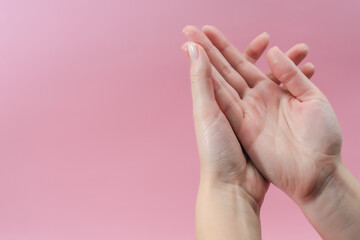 Obraz na płótnie Canvas Female hands moisturizer the cream on pink background. Skincare, Spa salon