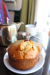 Darjeeling hi tea set up with vintage brass teapot, white cup, and tea strainer. Green tea. refreshments with Vanilla cake. Copy space