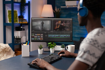 Professional videographer man working remote from home at montage film editing visual effects using...