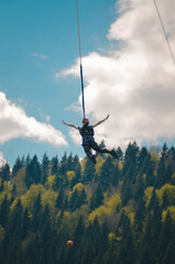 girl jumping with a rope on the background of the forest