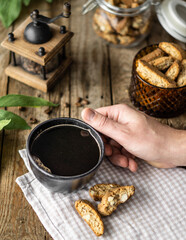 Top view of black coffee with Italian bakery cantuccini with almond over wood brown background,...