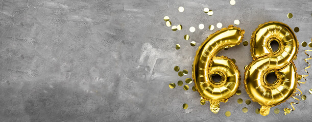 Yellow foil balloon number, number sixty eight on a concrete background. Greeting card with the inscription 68. Anniversary concept. for anniversary, birthday, new year celebration. banner,