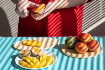 chef cutting fruits. Female hands cutting mango and passion fruit, fruit breakfast