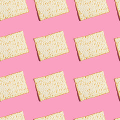 Seamless pattern with matzah bread for Jewish holiday Pesach on pink background.