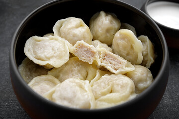boiled dumplings with chicken meat and sour cream