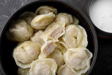 boiled dumplings with chicken meat and sour cream