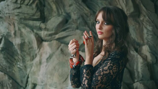 Portrait close-up female hands holding aspred red royal milk snake - sinaloa. Gothic fantasy woman dark queen of snakes and poison. Silhouette girl vampire. black vintage medieval dress. Face cropped