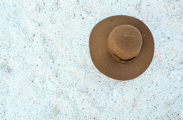 Fototapeta na wymiar woman's hat on a marble stones, seaside on marble beach in Greece Thassos island.