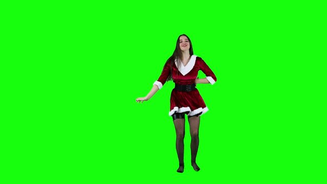 Attractive Christmas Mrs. Claus dancing in front of a green screen