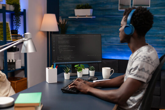 African american young programmer working remote from home at website design using programming binary codeson computer. Freelancer man coding digital business server typing infographics javascript