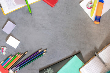 notebooks, school and office supplies lie on a gray background