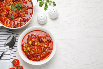 Tasty chili con carne served on white wooden table, flat lay. Space for text - obrazy, fototapety, plakaty