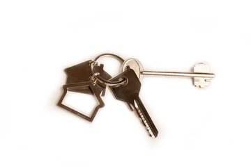 House key with a house shaped keychain, isolated on white background