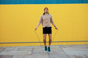 Obraz premium Young muscle man training outside. Fit handsome man doing exercise. Healthy lifestyle