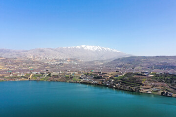 Fototapeta premium Hermon mountain covered with snow, over lake Ram, Aerial view.