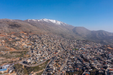 Hermon mountain ridge covered with snow during 2022 winter, with the town houses of Majd al Shams.
