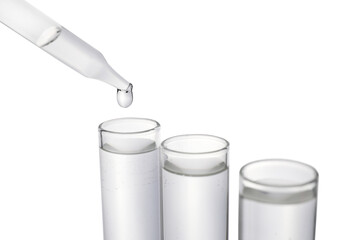 Dripping transparent liquid into test tube on white background, closeup