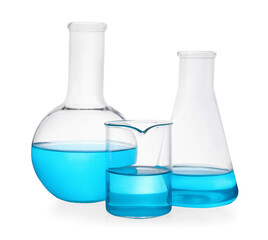 Different laboratory glassware with light blue liquid on white background