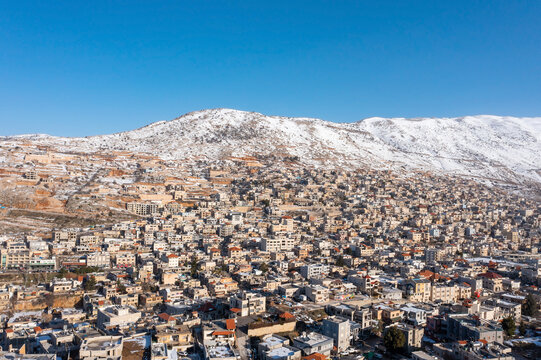Hermon mountain ridge covered with snow during 2022 winter, with the town houses of Majd al Shams.
