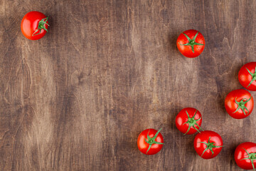 Wooden brown background with tomatoes