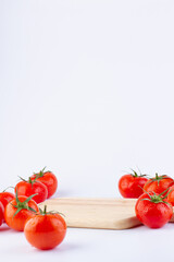 Background with wooden board pedestal and tomatoes