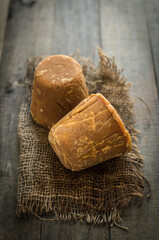 Blocks of organic Indian jaggery placed  on a grunge background. Healthy, unrefined Gur- a substitute for unhealthy sugar.