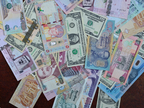 Assorted currency notes from various countries in the world includes USA, Saudi, UAE, Kuwait, Oman, Kenya, Thailand, Egypt etc. Background photo for foreign  exchange.