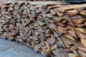 A woodpile of chopped pine in the forest closeup