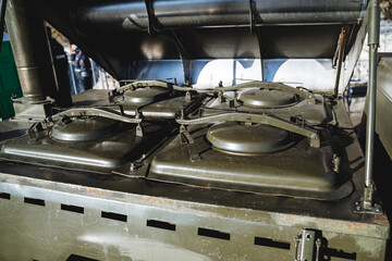 Close-up of the army kitchen. Boilers for cooking for soldiers. Military thermos for porridge. The green color of the mobile kitchen.