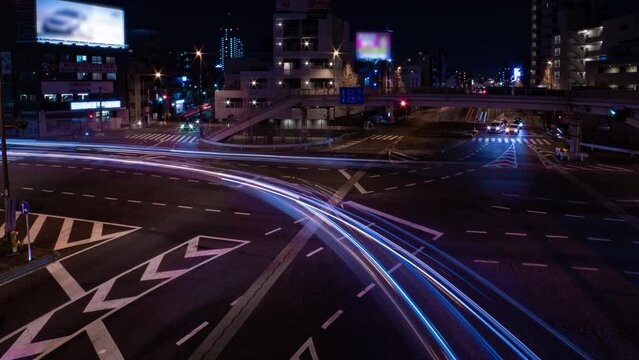 A night timelapse of the traffic jam at the city street in Tokyo wide shot panning
